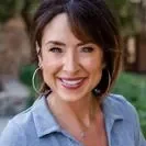 A woman with brown hair wearing a blue shirt.